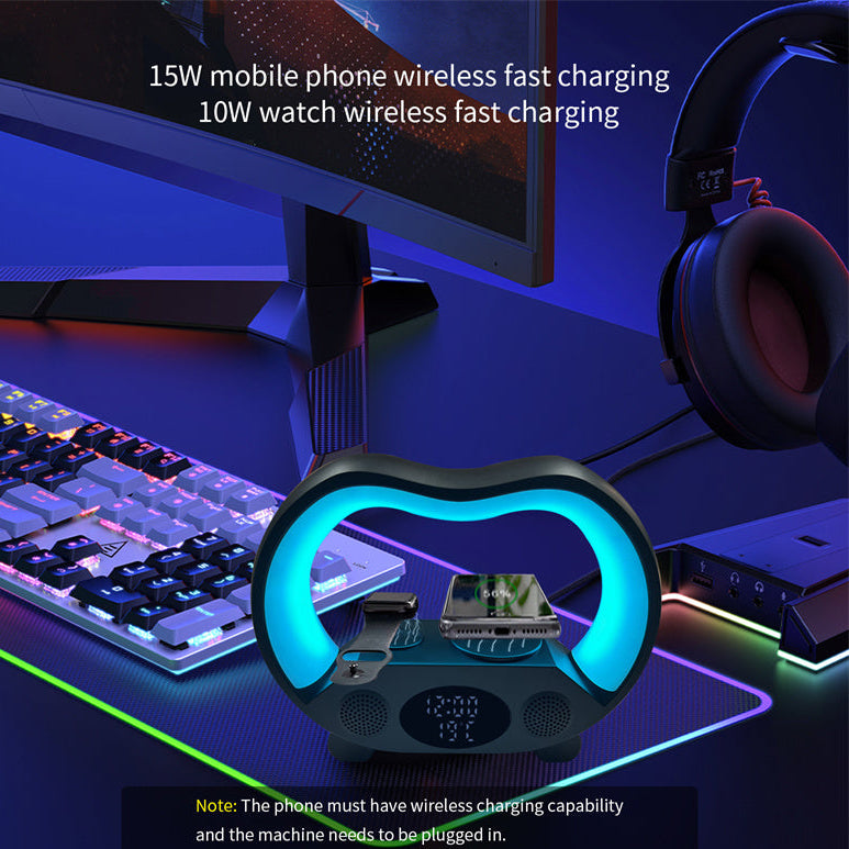 Gaming setup with a wireless charging pad, monitor, keyboard, and headphones on a desk.