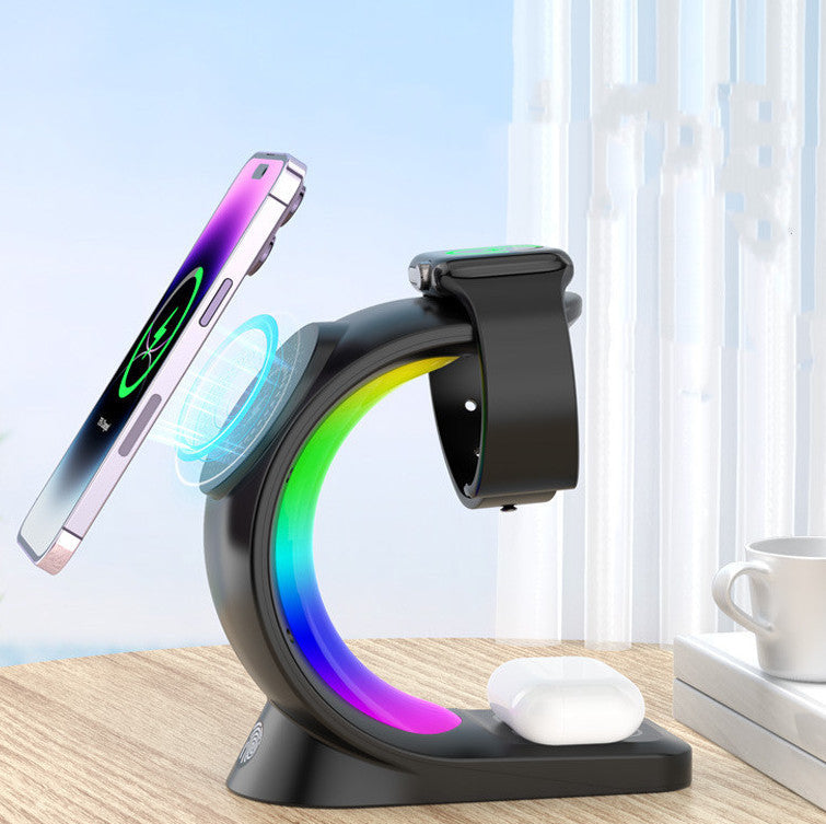 Multi-device charging stand with smartphone, smartwatch, and wireless earbuds on a desk.
