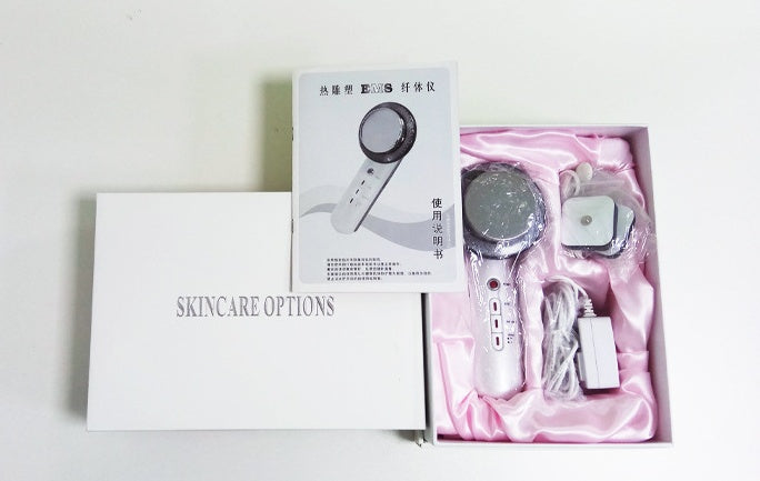 Skincare device with packaging and accessories on a light background