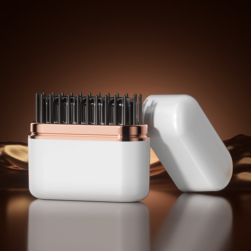 Hairbrush with white handle and rose gold accents on a reflective surface