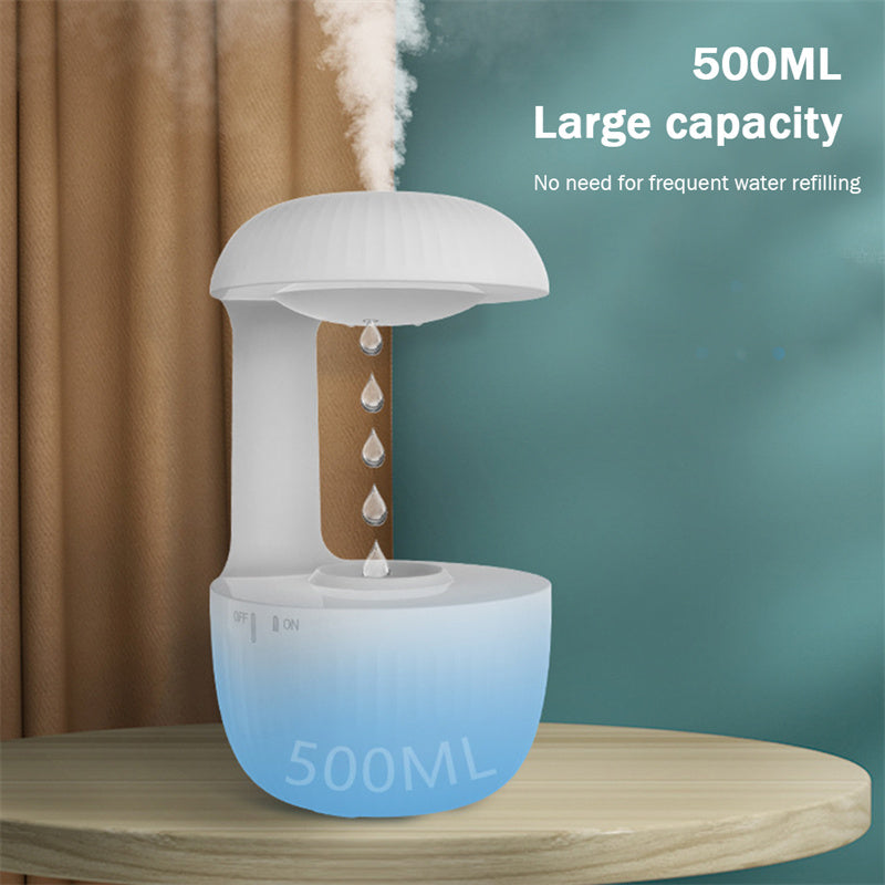 White and blue humidifier with steam rising, placed on a wooden surface against a green wall.