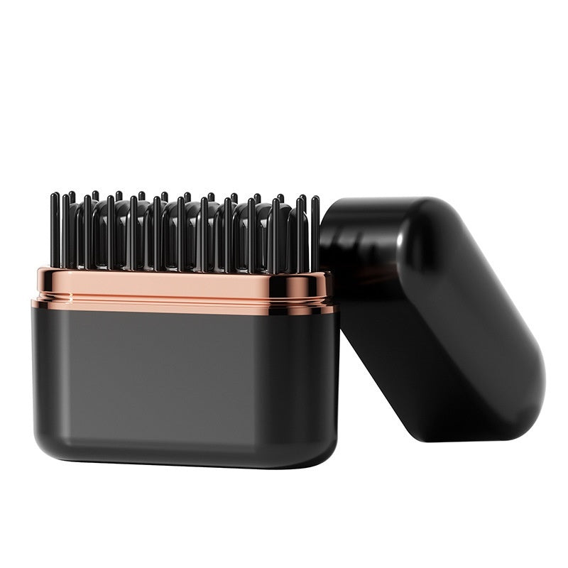 Black and rose gold hairbrush on a white background