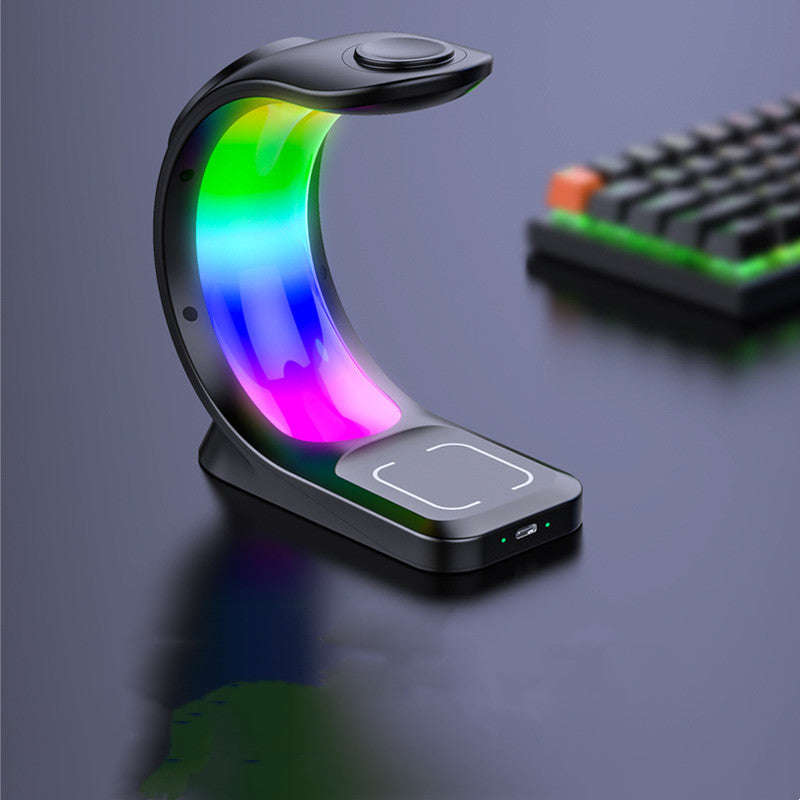 Colorful LED lamp with wireless charging pad on a dark surface