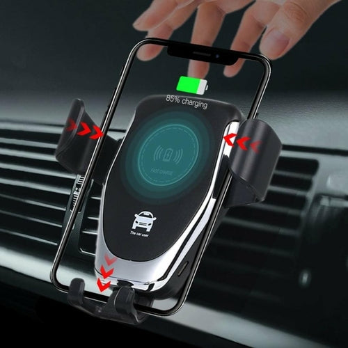 Wireless car charger in a car's air vent with a hand reaching towards it.