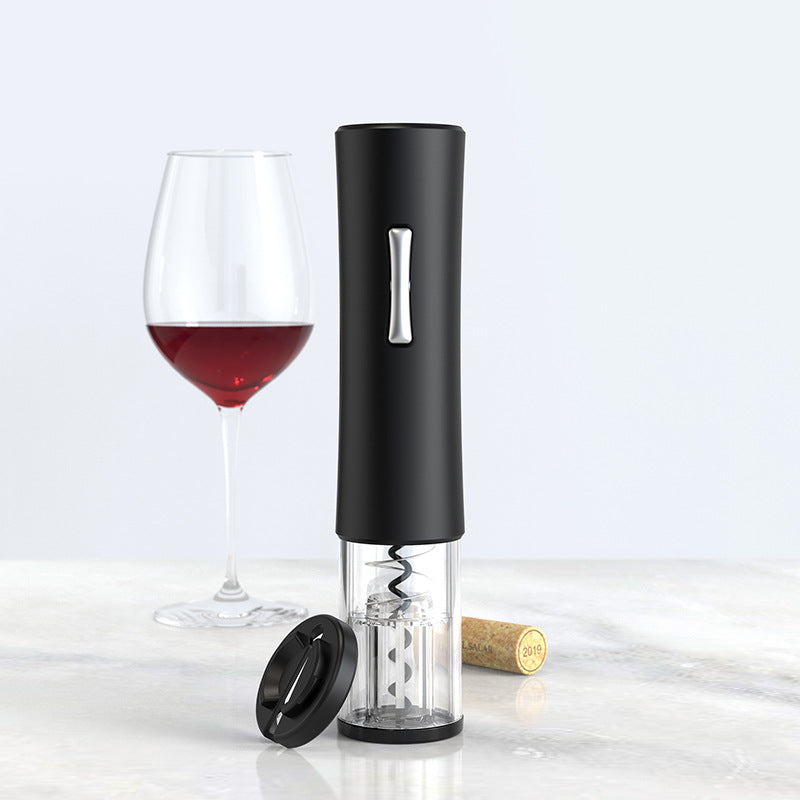 Black electric wine opener with a glass of red wine and cork on a light background