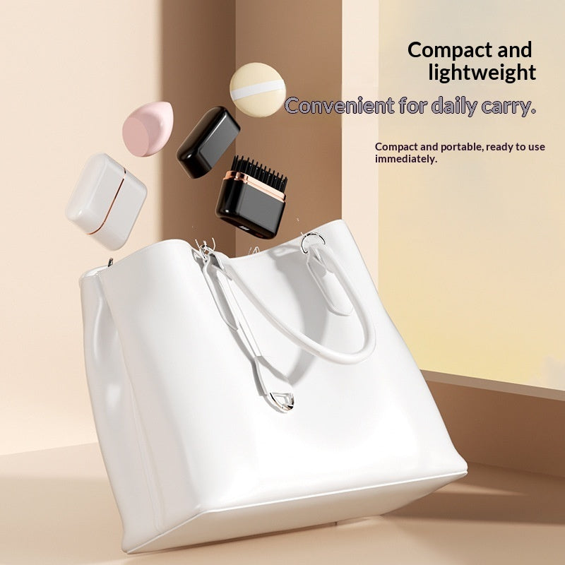 White handbag with cosmetic items on a beige background