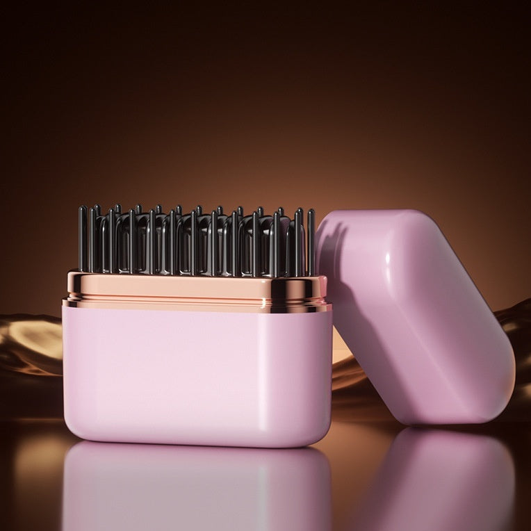 Pink hairbrush with black bristles on a reflective surface